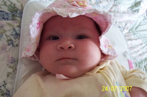 2000 Ford Crown Victoria - A baby wearing a pink sun hat and yellow onesie is shown with a date stamp of 24/07/2007.