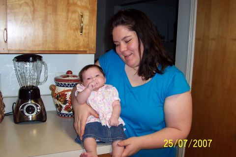 2000 Ford Crown Victoria - Woman and baby in kitchen, dated 25/07/2007.
