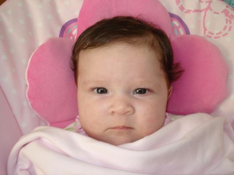 2000 Ford Crown Victoria - A baby is shown in a close-up shot, wrapped in a pink blanket.