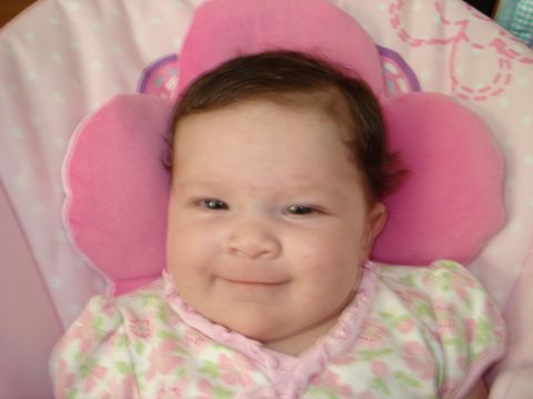 2000 Ford Crown Victoria - Baby smiling in a pink flower-shaped pillow.