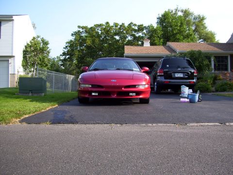 1995 Ford Probe - Red 1995 Ford Probe is parked in front of a house with a black SUV behind it.
