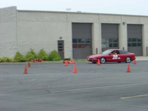 1997 Ford Probe - A red 1997 Ford Probe navigates a course marked by orange traffic cones.