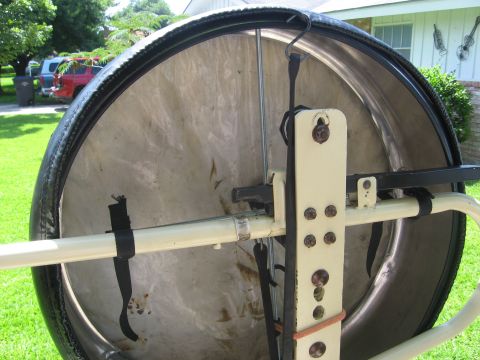 1979 Ford Bronco - Close-up of a spare tire carrier mechanism, showing its mounting hardware and straps.