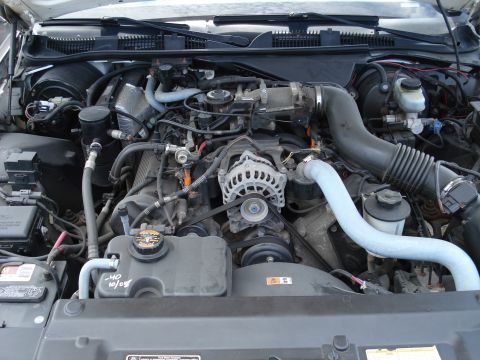 2000 Ford Crown Victoria - Engine bay detail with handwritten date on the coolant reservoir.