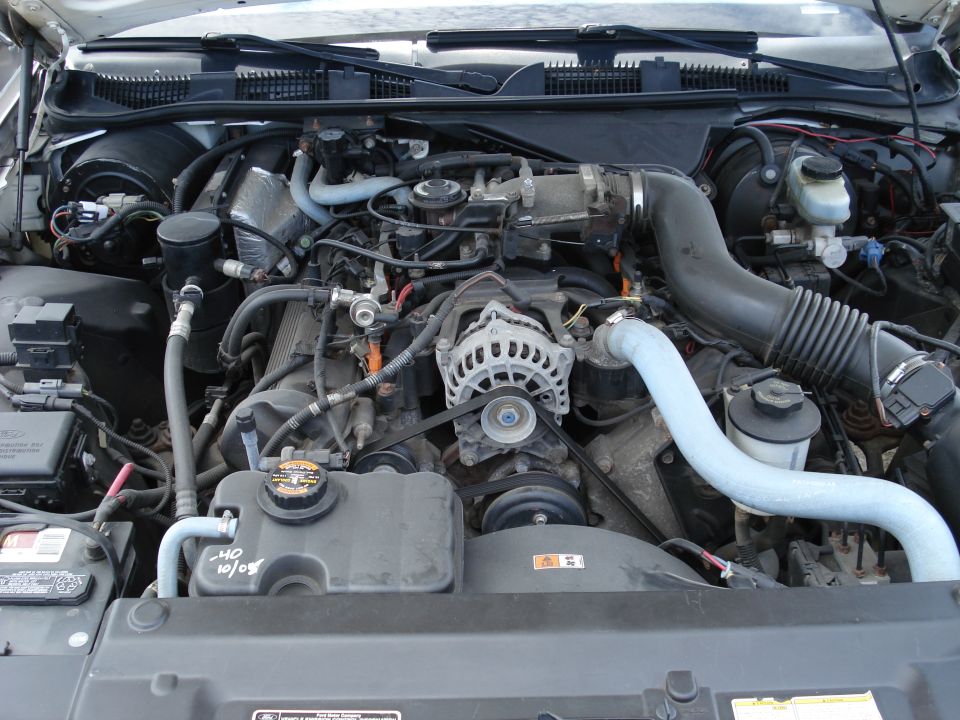 Engine bay with visible text '40 10/09' on coolant reservoir