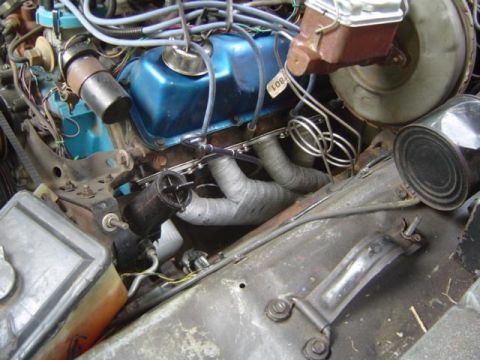 1979 Ford Bronco - Engine bay details with blue valve covers and exhaust components visible.
