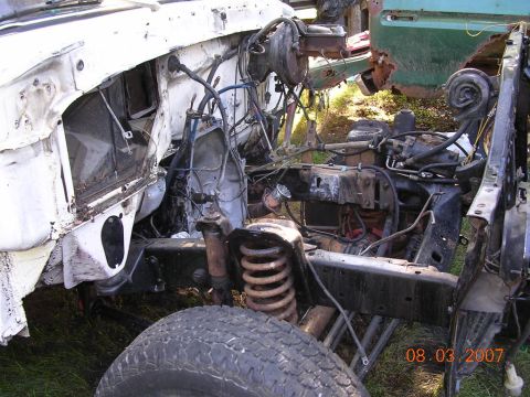 1978 Ford Bronco - The front chassis and engine of a white vehicle are visible, with another vehicle in the background. The registry claims it is a 1978 Ford…