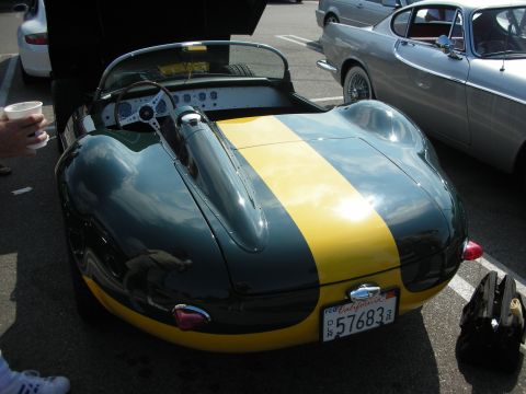 1998 Ford Crown Victoria - A classic dark green and yellow racing car is parked next to other vehicles, showing its rear end and California license plate.
