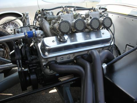 1998 Ford Crown Victoria - Close-up of a custom V8 engine chrome valve covers and multiple carburetors.