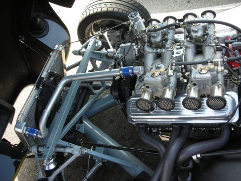 1998 Ford Crown Victoria - The engine bay of a custom vehicle features a V8 engine with multiple carburetors and a large radiator.