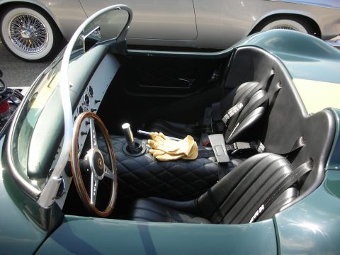 1998 Ford Crown Victoria - The interior of a classic green sports car is visible, with a focus on the quilted seats and racing harnesses.