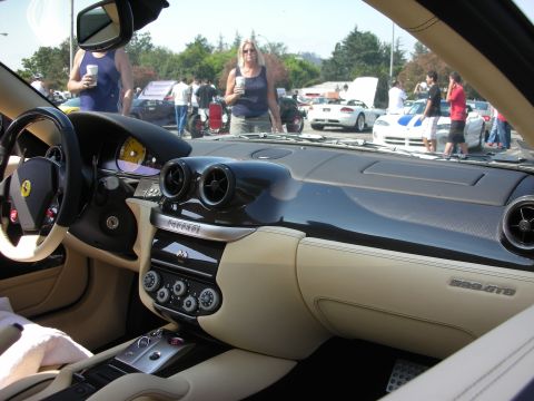 1998 Ford Crown Victoria - Interior view of a Ferrari at a car meet, with other vehicles and attendees visible outside.