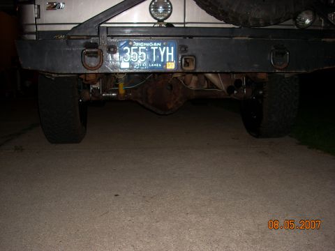 2000 Chevrolet Tahoe - The rear axle and bumper assembly of a vehicle are visible, along with a Michigan license plate.