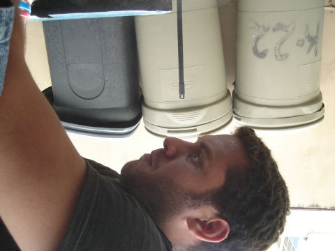 1995 Mazda MX-6 - A person works on what appear to be automotive filters or canisters.