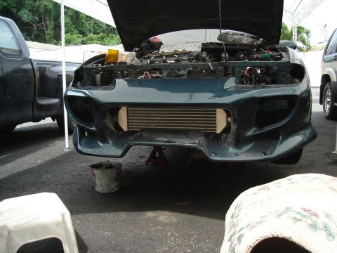 1995 Mazda MX-6 - Car front end with hood open, showing intercooler and engine components, parked outdoors.