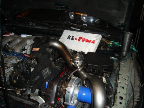 1995 Mazda MX-6 - Custom turbo setup in an engine bay, racing gloves and 'KL-POWA' branding on insulation.