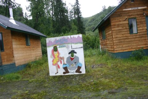 2003 Jeep TJ - A painting of two figures is displayed in front of cabins in a wooded area.