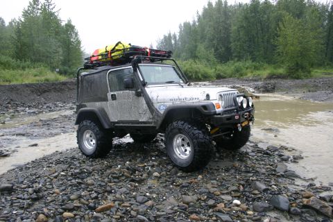 2003 Jeep TJ - Modified Jeep Wrangler TJ Rubicon equipped for off-road use on a gravelly river bank.