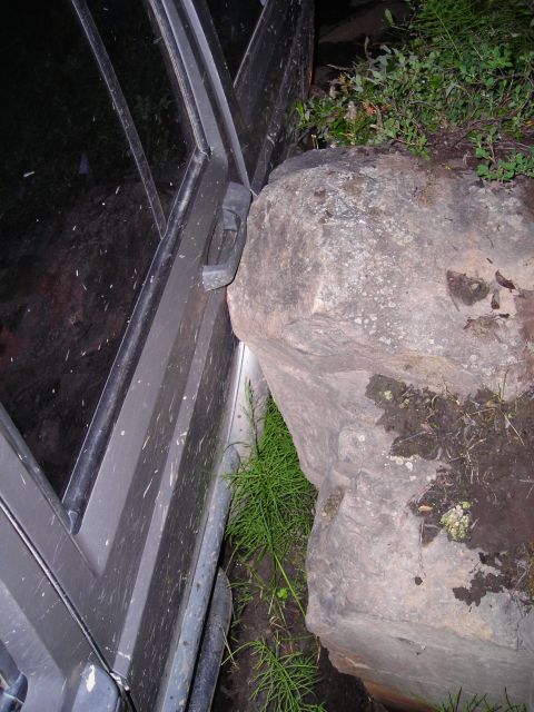 2003 Jeep TJ - Jeep door is stuck against a large rock on the trail.