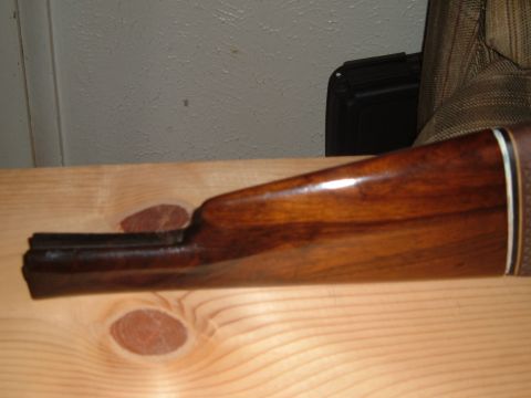 1919 Yugo Vega - Wooden gun stock shown from the side, resting on a wooden surface.