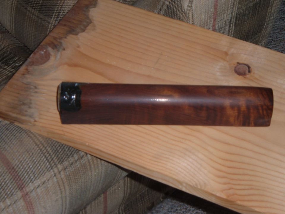 Polished wood rifle forend resting on a board