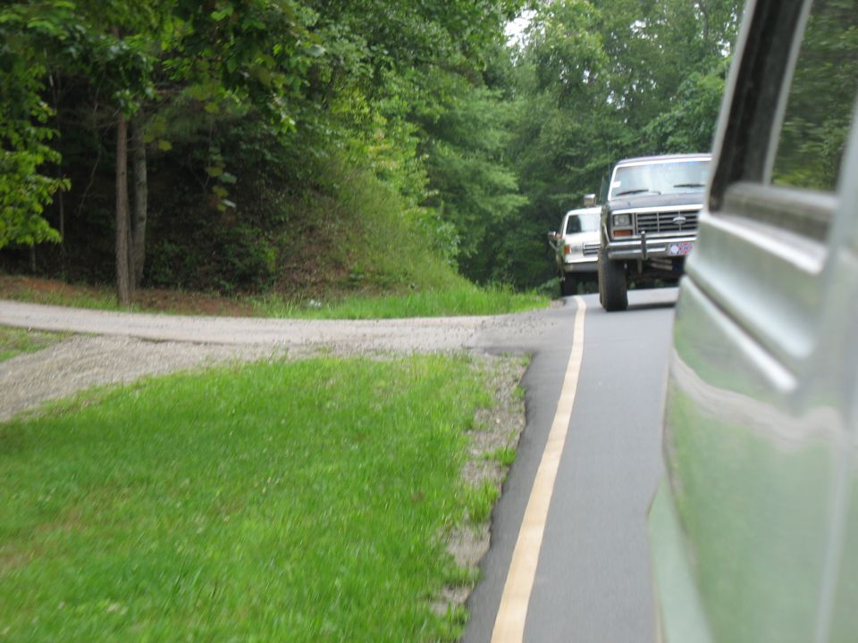 Front view of a dark 1980s Ford F-Series truck with a license plate