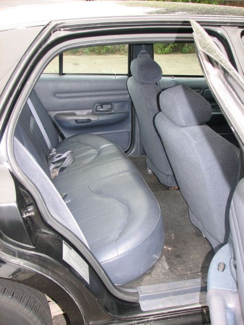 2000 Ford Crown Victoria - Interior view of the rear passenger area of a car, showing the seats and door panel.