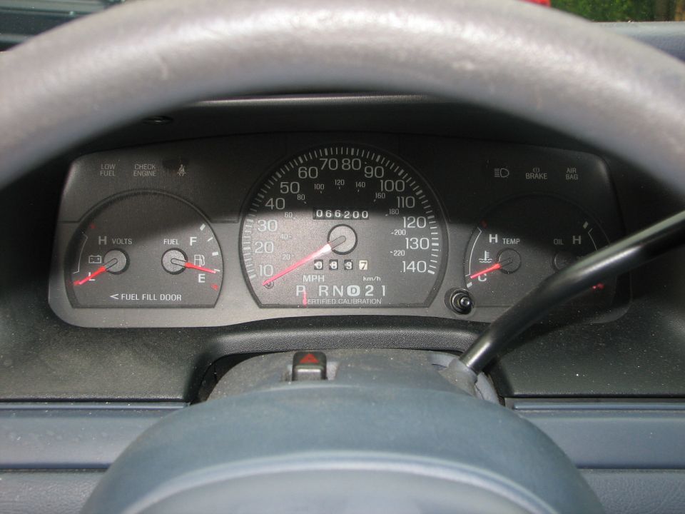 2000 Ford Crown Victoria dashboard with speedometer, fuel gauge, voltmeter, and temperature gauge visible