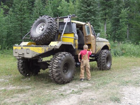 1990 Ford Bronco - This heavily modified truck, likely from the 1970s, stands ready for off-road adventure.