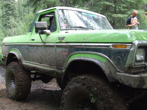 1990 Ford Bronco - This heavily modified 1978 Ford Bronco is shown off-road, covered in mud.