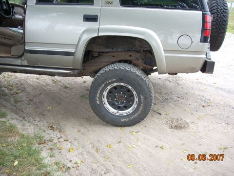 2000 Chevrolet Tahoe - Rear view of a silver Chevrolet Tahoe, showing the spare tire and rear bumper.
