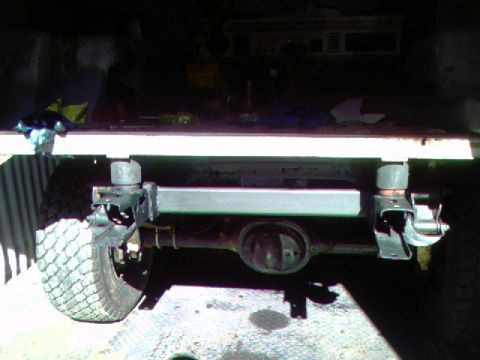 1974 Ford Bronco - Close-up of a vehicle's rear axle and suspension system, possibly undergoing maintenance or upgrade.