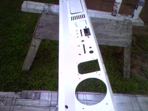 1974 Ford Bronco - A white dashboard panel is shown outdoors, resting on sawhorses. It has many cutouts for instruments.