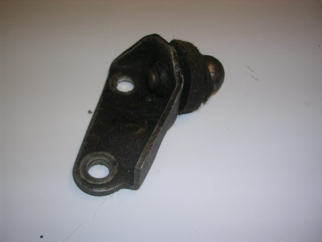 Black metal bracket with rubber bushing attached, viewed from an angle