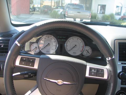 1975 Dodge Dart - Dashboard gauges and steering wheel of a car, with a pickup truck visible through the windshield.