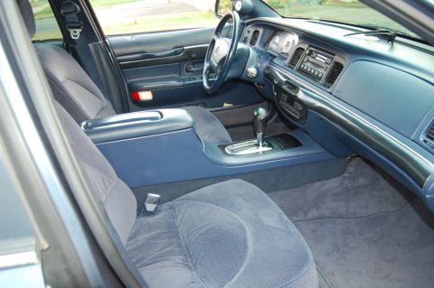 1985 Mercury Grand Marquis - The interior of a 1998 Mercury Grand Marquis shows a blue center console, dashboard, and seats.