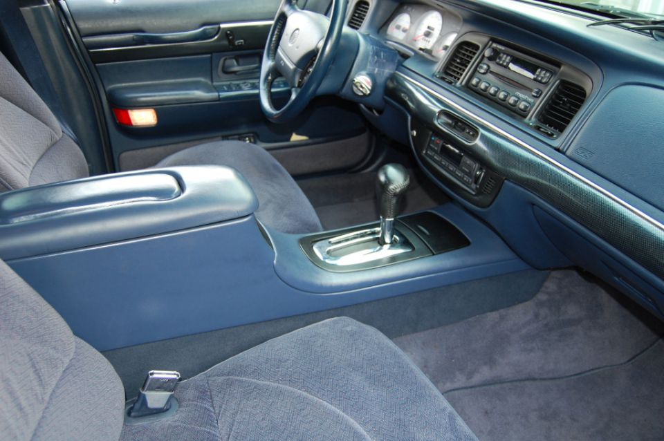 Blue Mercury Grand Marquis interior with console floor shifter, white-face gauges and carbon-look dash trim