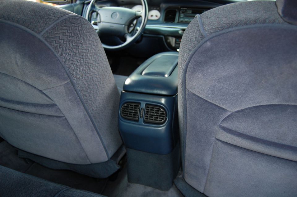 Blue velour front seats and console viewed from the rear of a sedan