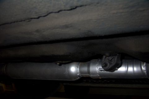 1994 Dodge Stealth - Underside view of a vehicle's exhaust system, showing a pipe and hanger assembly.