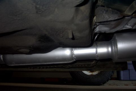 1994 Dodge Stealth - Close-up view of a vehicle's undercarriage, focusing on the newly installed exhaust system components.