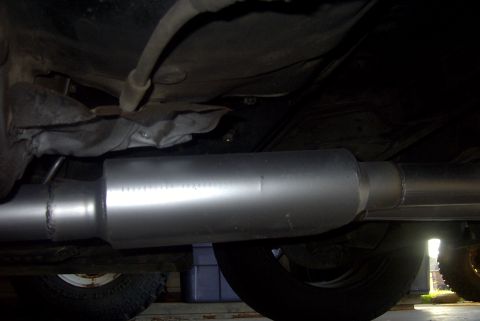 1994 Dodge Stealth - The underside of a vehicle shows a newly installed exhaust system, including the muffler and piping.