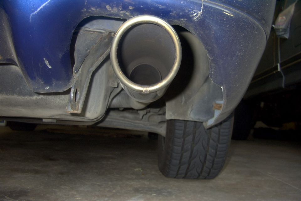 Blue car's rear exhaust pipe and damaged bumper