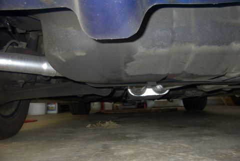 1994 Dodge Stealth - The undercarriage of a vehicle is shown, focusing on the fuel tank and a dual exhaust system.