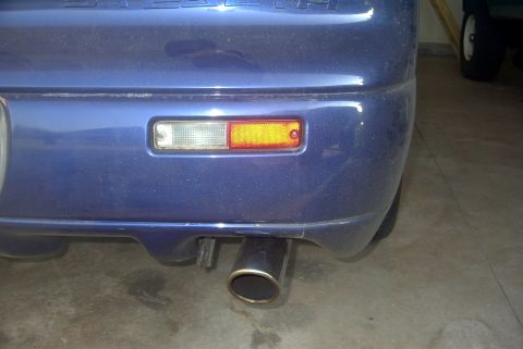 1994 Dodge Stealth - Rear view of a blue 1994 Dodge Stealth showing the bumper, exhaust, and reflector.