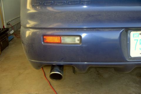1994 Dodge Stealth - Rear view of a blue 1994 Dodge Stealth, showing the bumper, exhaust, and taillight assembly.