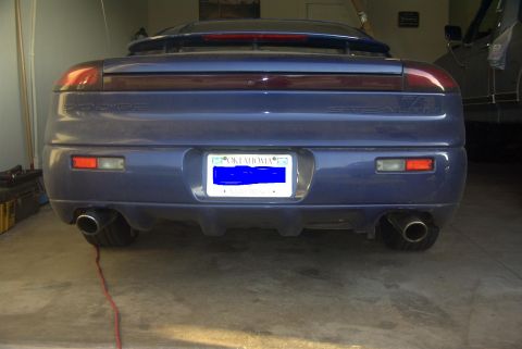 1994 Dodge Stealth - The rear of a blue 1994 Dodge Stealth is shown, its dual exhaust pipes and taillights.