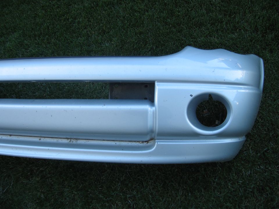 Silver front bumper with fog light opening