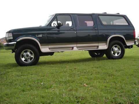 1995 Ford C-150 (Centurion Conversions) - Side profile of a 1995 Ford F-250 Centurion Conversion Van parked on grass.