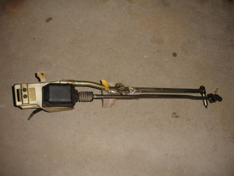 1993 Ford Taurus - A car door latch mechanism is shown against a concrete surface.