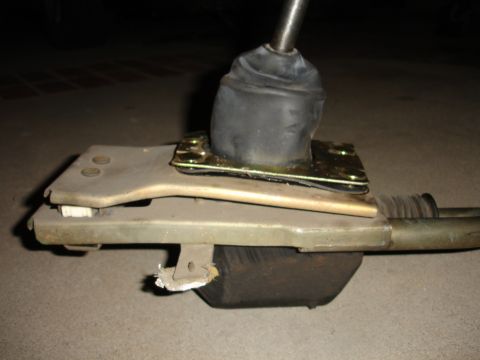 1993 Ford Taurus - Close-up of a vehicle's manual transmission shifter assembly, showing the mechanical components.